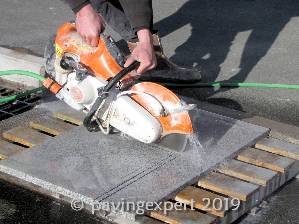 hand held saw cutting paving