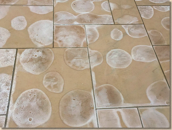 severe chemical staining on stone paving