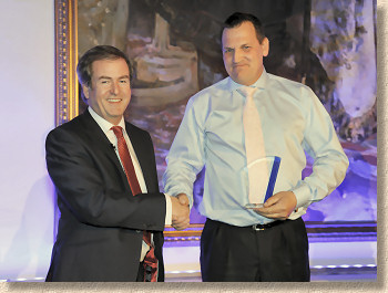 George Jenkins of Arun Driveways being awarded prize by Chris Droogan