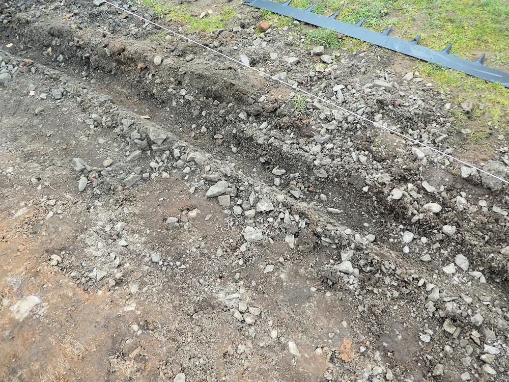 cut trench through stony ground