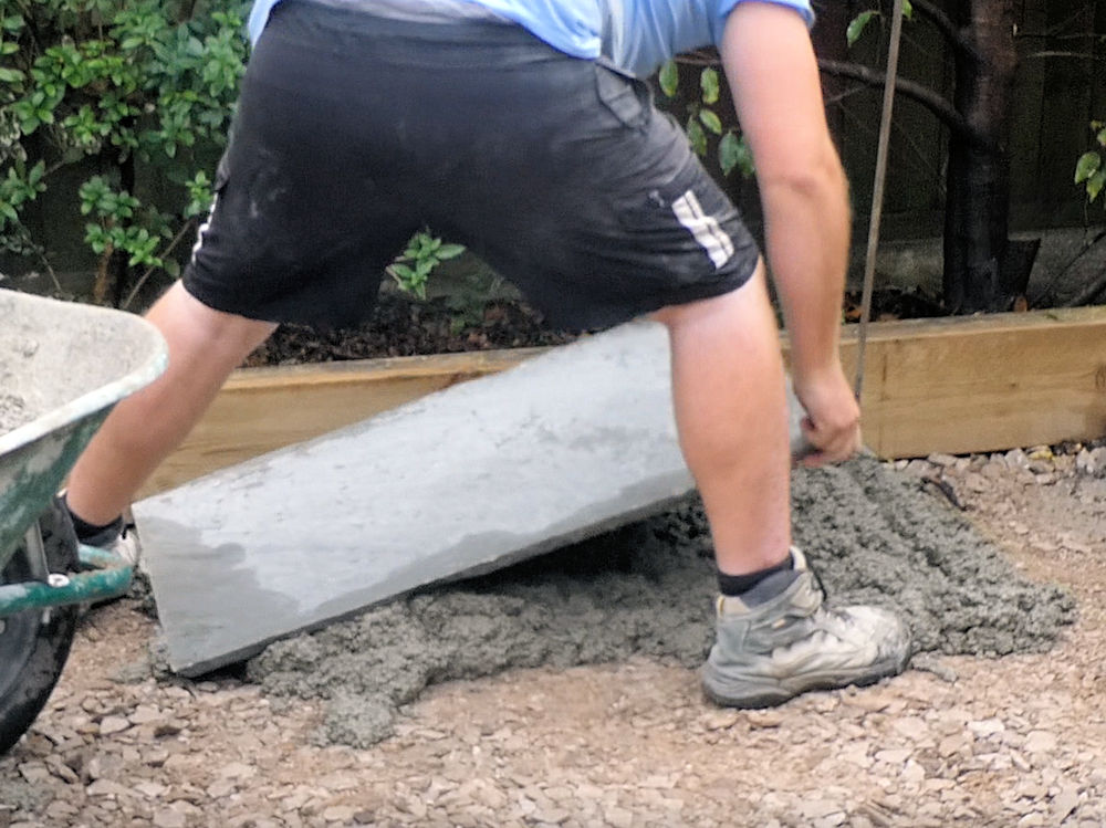 lay flagstone onto prepared bed