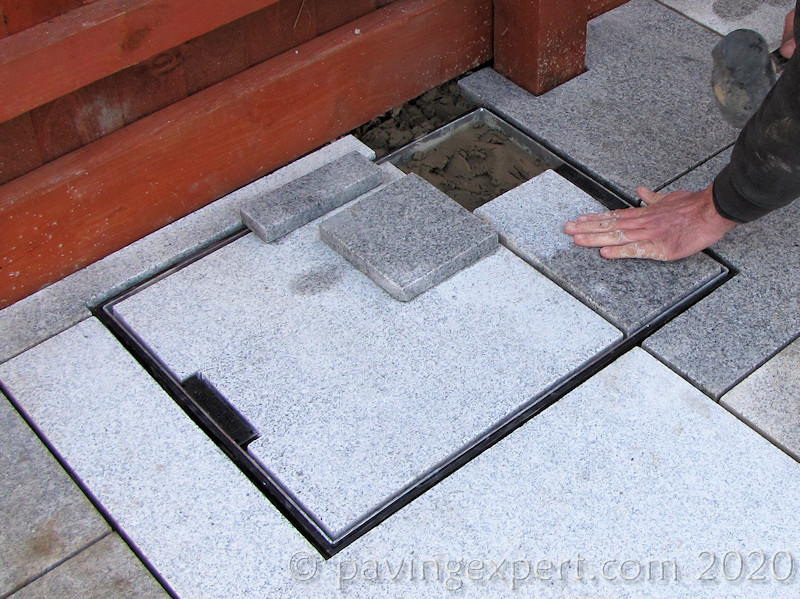 continue infilling tray with paving
